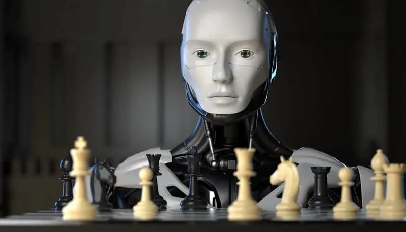 Robot humanoide de rostro blanco frente a un tablero de ajedrez, con piezas claras y oscuras en primer plano