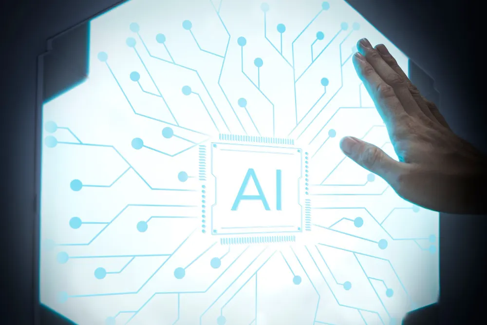 Mano apoyada sobre un panel luminoso hexagonal con un chip central marcado AI y trazos de circuito azul.