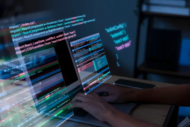 Manos que teclean en una laptop mientras líneas de código de colores se superponen a la pantalla, imagen del trabajo de desarrollo de software